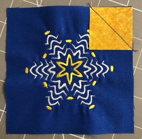 Stitch along the diagonal from corner to the opposite corner of the square.