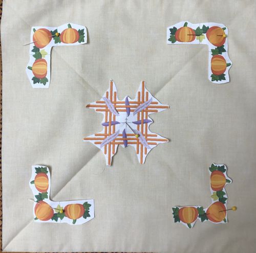 Paper print-outs in the center of the quilt to determine the position of the embroidery.