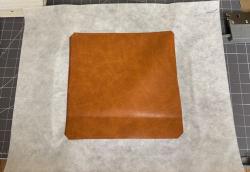 Stitch the piece of faux leather to the stabilizer along the perimeter.