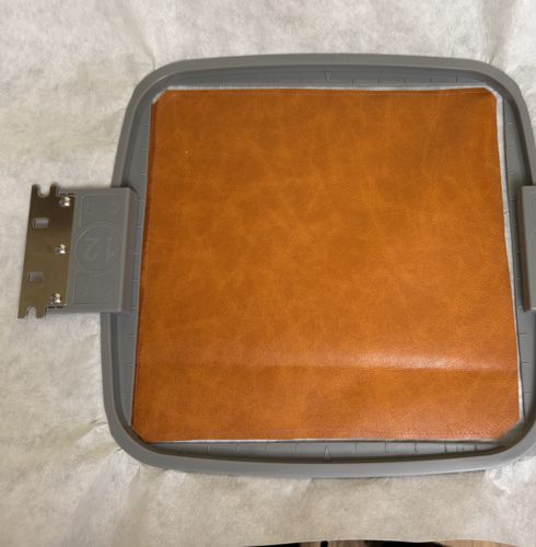 Hoop the stabilizer with stitched-on faux leather.