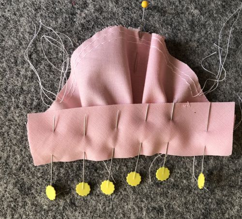 Pin the sleeve cuff to the sleeve's hem.