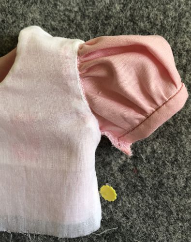 Tuck the seam allowance inside. Handstitch the lining to the sleeve around the armhole.