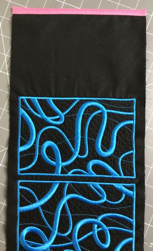 Finish the raw edge of the blank panel with the bias tape.