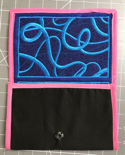 Fold the blank panel onto the embroidered panel, wrong sides together.