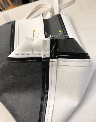 To shape the bottom, fold the bottom of the bag so that the bottom and the side seams align. Pin.