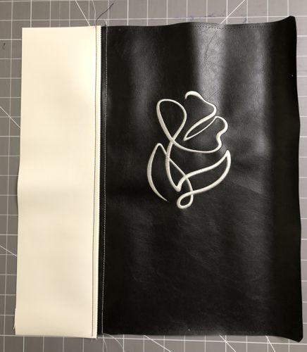 Sew the white strip to the left edge of the black panel.