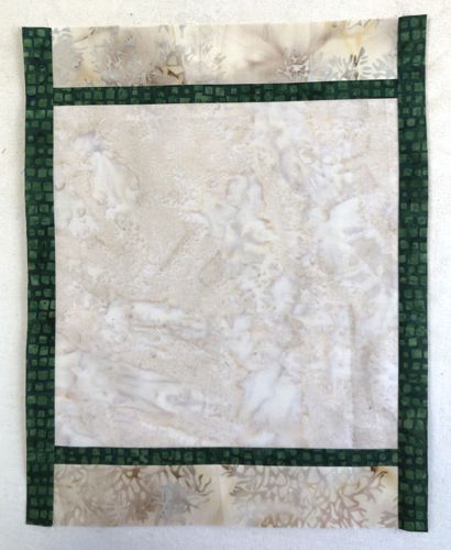 Sew the green 1" x 14 1/2" strips to the left and right edges of the working piece.