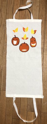 The handles are stitched to the short sides of the bag.