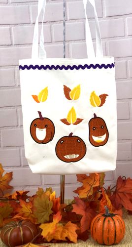 Finished white canvas tote with Jack-o-Lantern and leaf embroidery