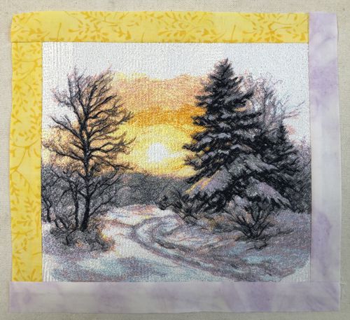 Pale lilac borders are sewn to the bottom and right edges of the embroidery.