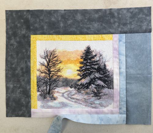 A dark gray strip is attached to the left edge of the piece.