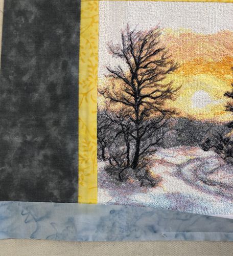 The stitching of the blue strip to the bottom is finished.