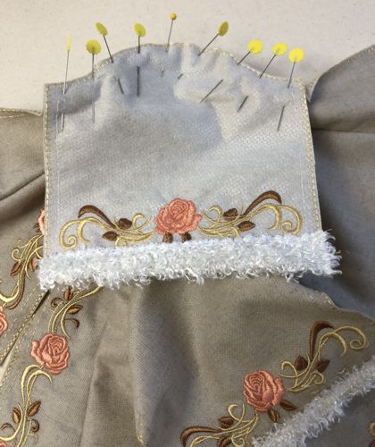 A sleeve is pinned to the armhole.