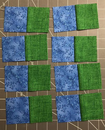 Blue and green squares are stitched into 2-color strips.
