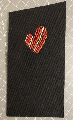 An unfinished mug rug with embroidery.