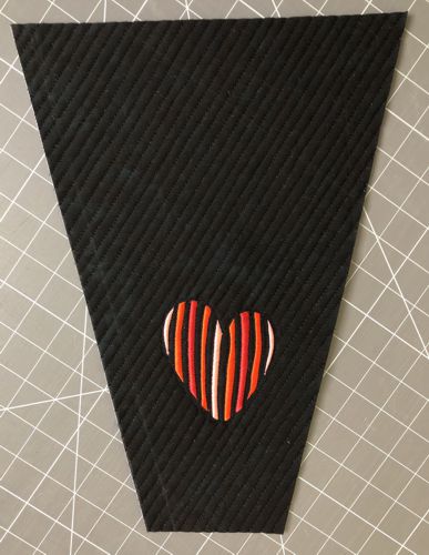 An unfinished mug rug with embroidery.