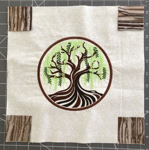 Brown squares stitched in the corners of the central part.