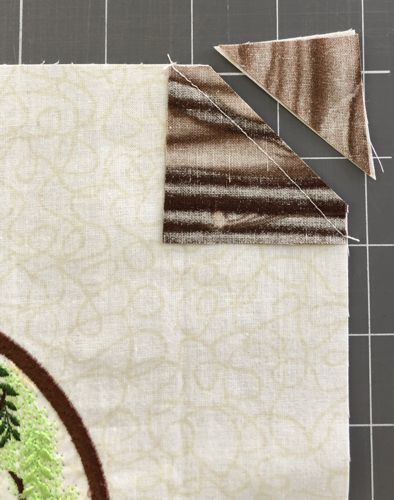 The excess fabric is cut along the diagonal with seam allowance 1/4