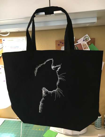 Black canvas tote with cat silhouette embroidery.