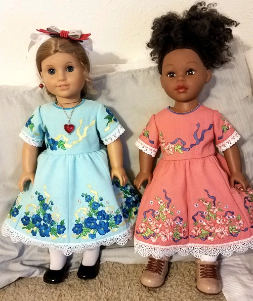 Two 18-inch dolls in dresses with flower embroidery
