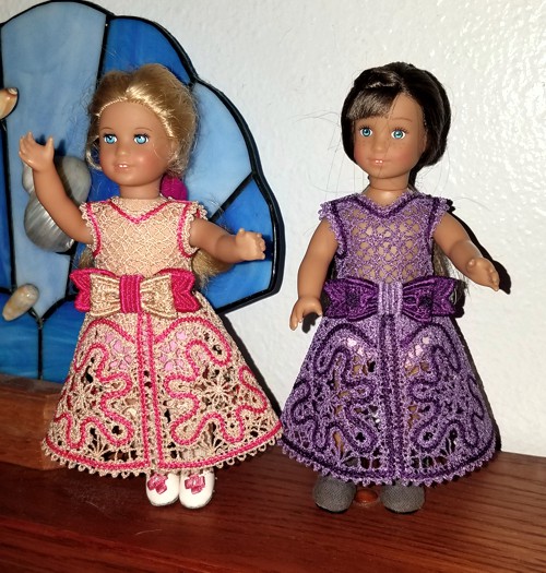 Two 6-inch dolls in lace dresses.